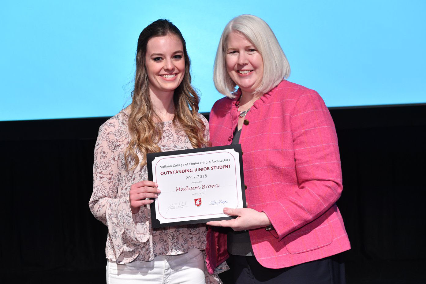Madison Broers stands next to Mary Rezac holding her award.