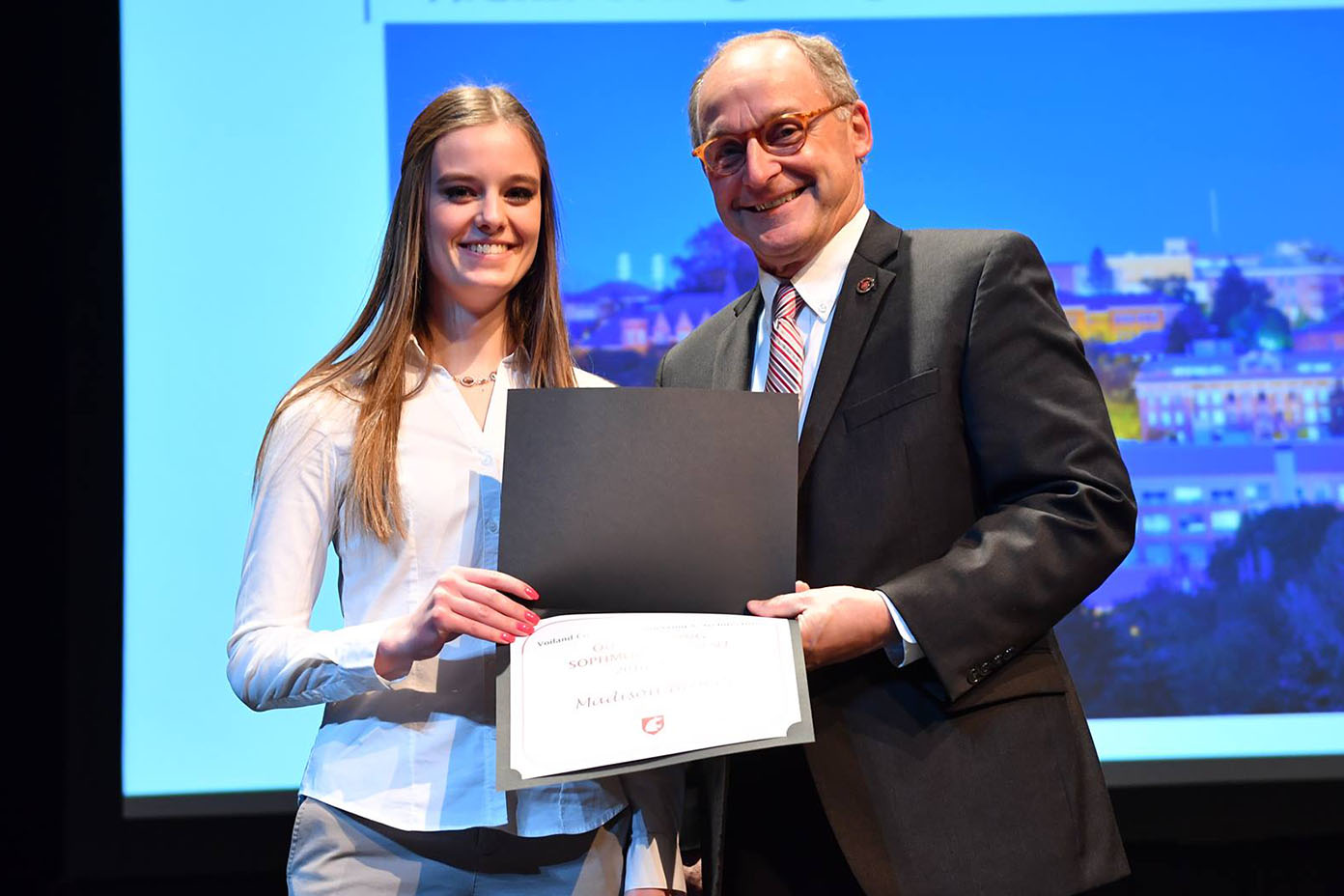 Madison Broers stands next to Don Bender holding her award.