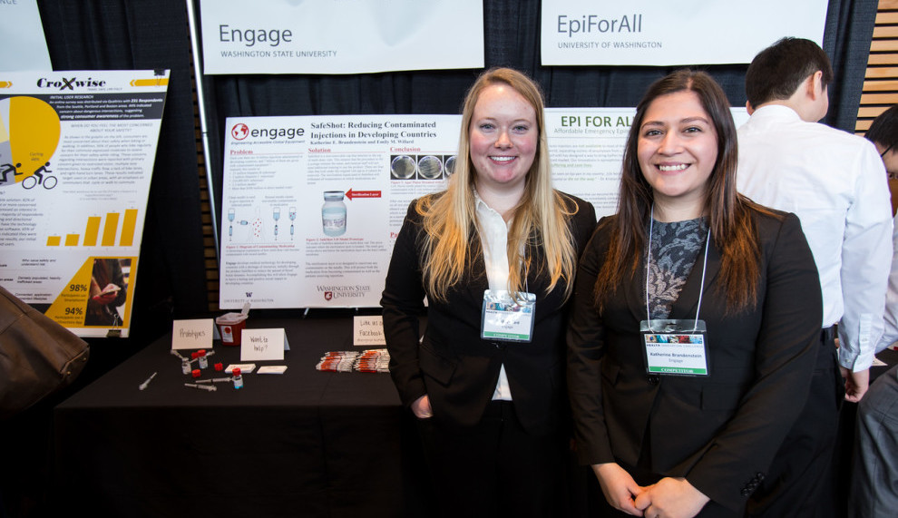Emily and Katherine pose next to their product display at the Health Innovation Challenge.