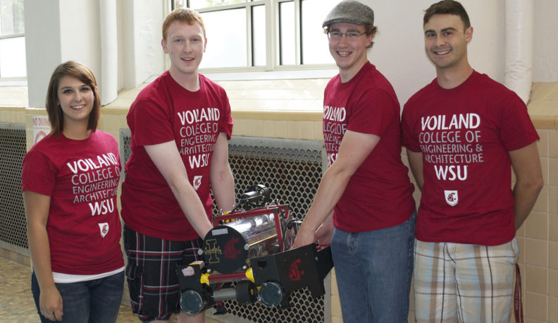 Four RoboSub Club of the Palouse students displaying their robosub.