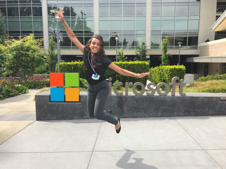 Christina Paoletti jumping in front of the Microsoft sign.