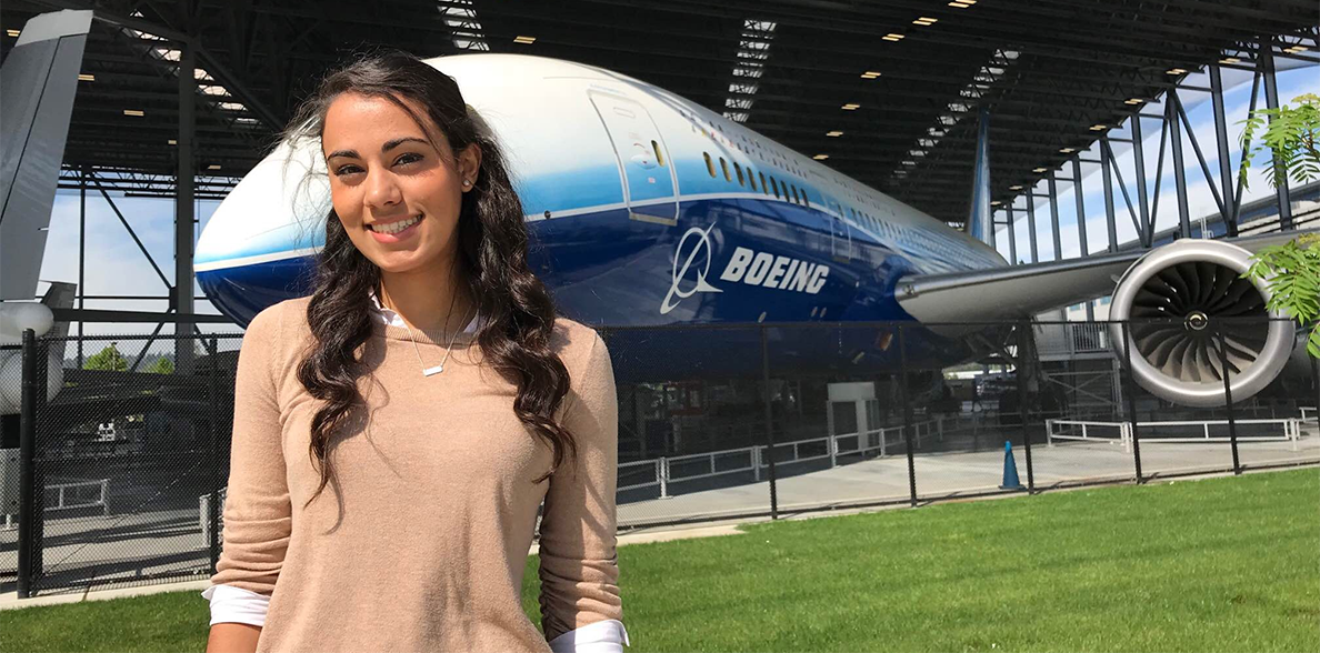 Christina Paoletti posing in front of a Boeing airplane.