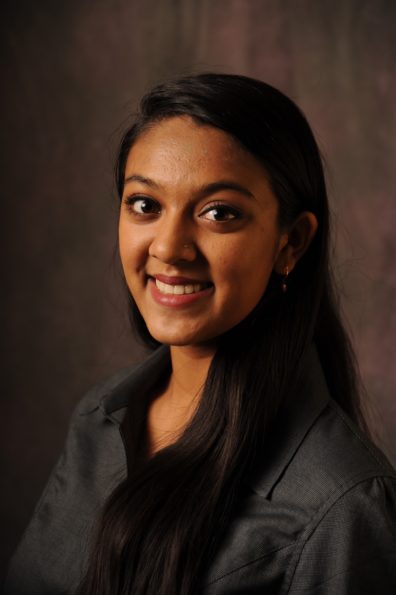 Smiling woman with long, dark hair.