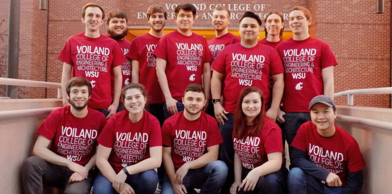 Thirteen club members wearing Voiland College t-shirts pose in front of Dana Hall in Pullman, WA.