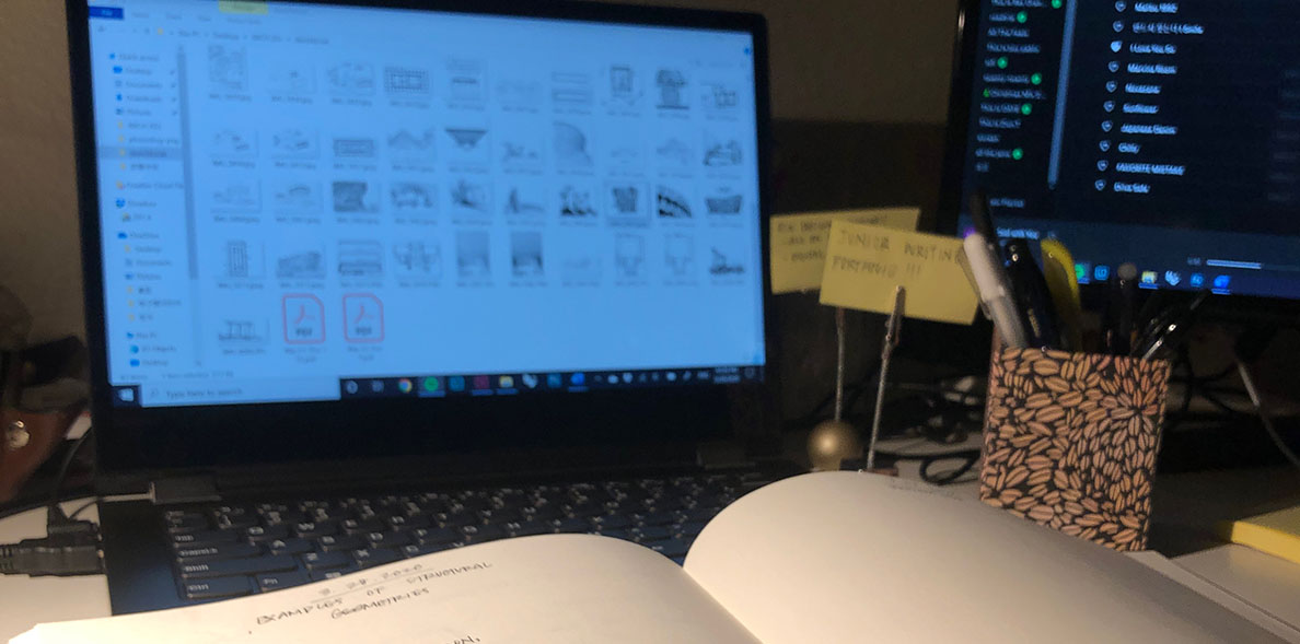 Open book in front of a laptop.