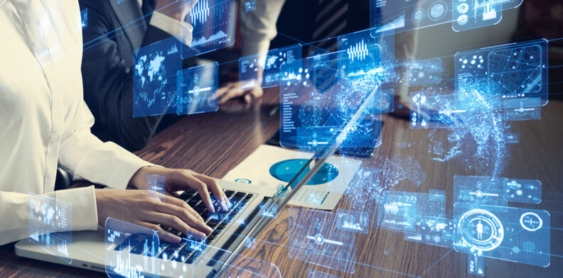 Person working at a laptop overlaid with transparent statistical images.