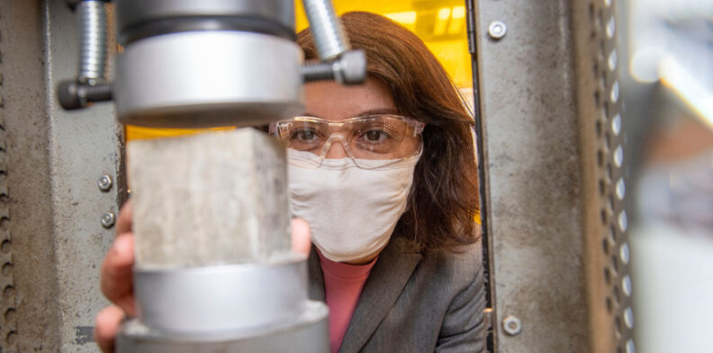 A researcher holds a concrete sample.