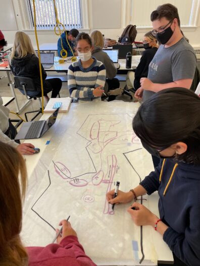 Students working together on a design concept in their lab.