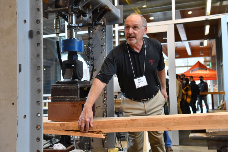 Don Bender points to a split in a board.