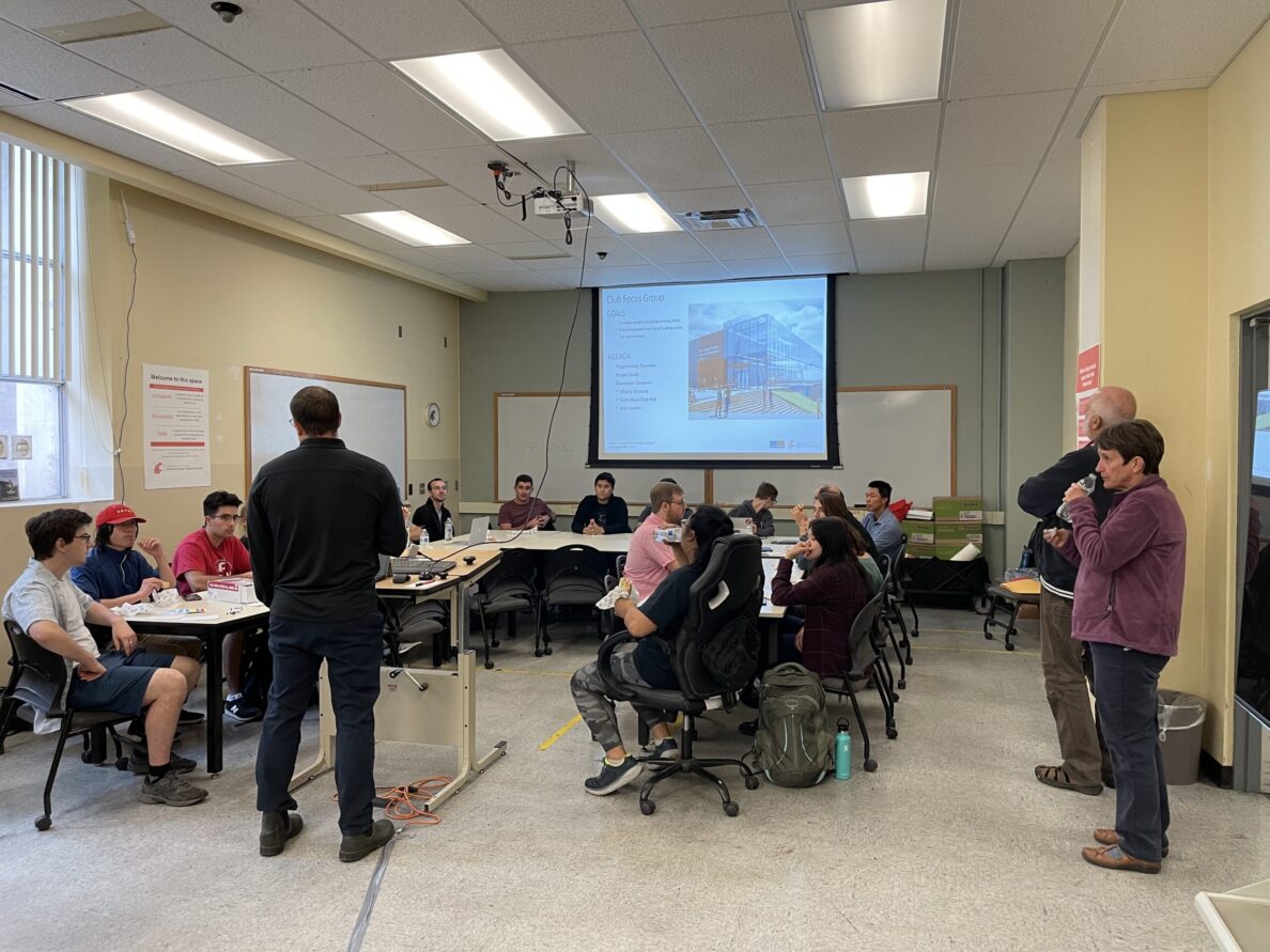 People sitting around a u-shape table learning about a planned new building.