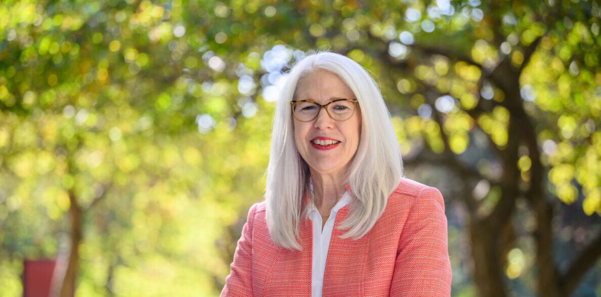 Mary Rezac standing outdoors with her arms crossed.
