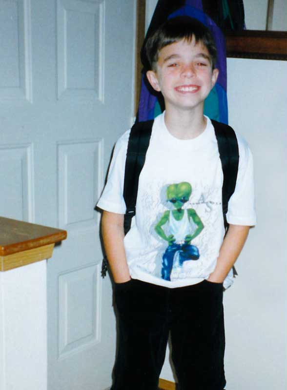 Young Ian Richardson wearing a backpack.