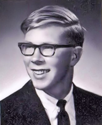 Black and white portrait of David Fallen wearing glasses and a suit and tie.