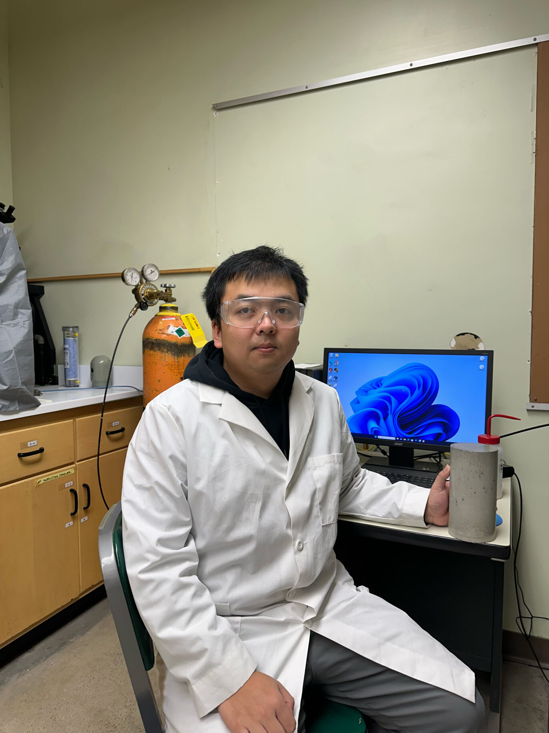 Graduate student Zhipeng Li holding a concrete sample.