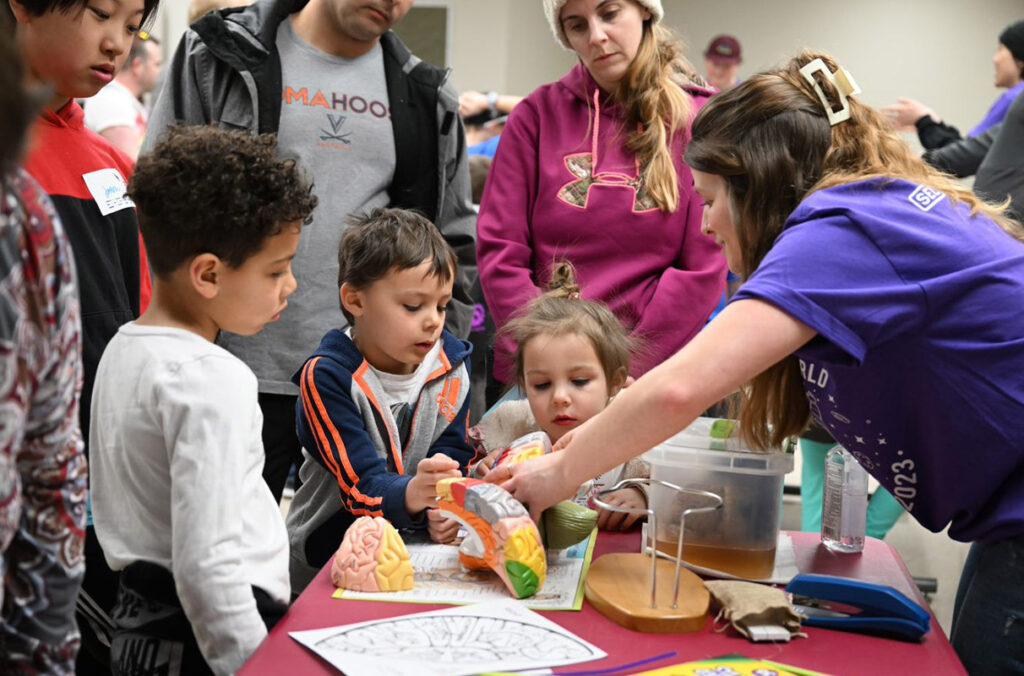 Children work with a presenter at Kids Science and Engineering Day.