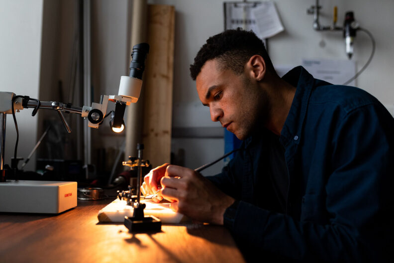 Man working under a desk light