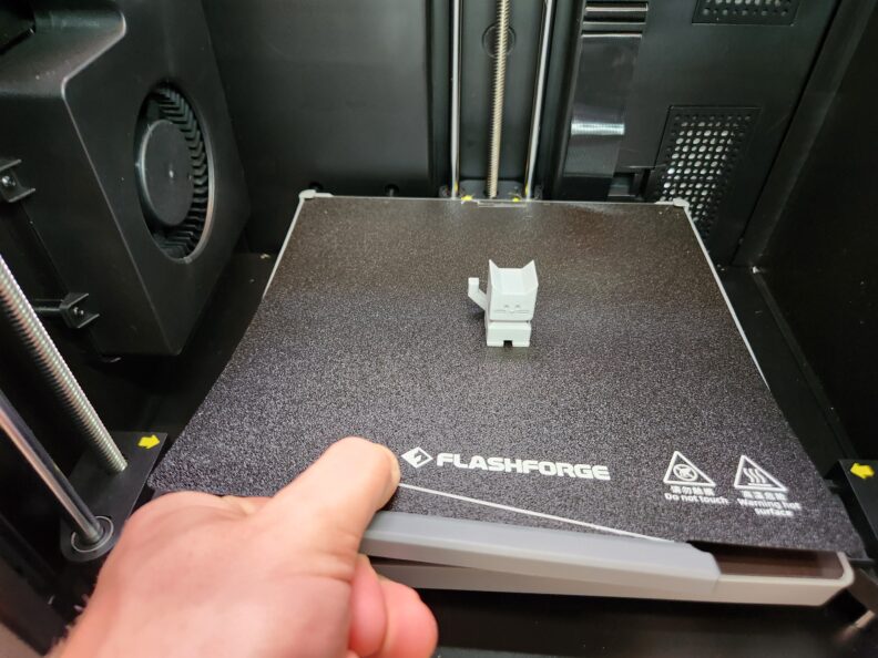 Picture of removing print from Adventurer 5M Pro build plate