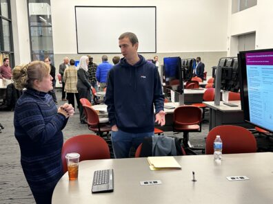 In foreground from left to right, Jennifer McCullough and James Crabb at student research poster presentation