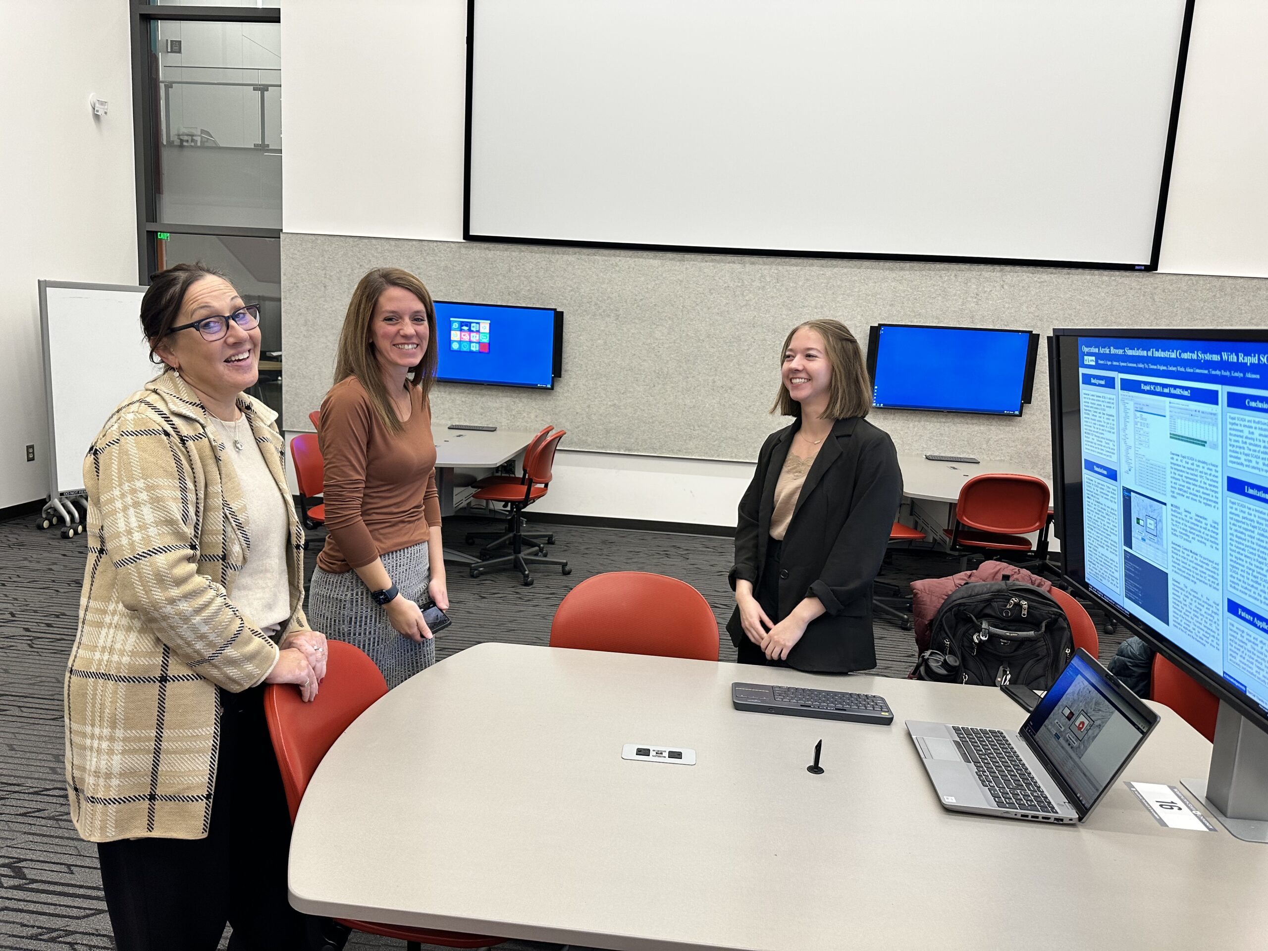 From left to right, Patti DeVoe, Katie Morrissette, and Katelyn Atkinson at student research poster presentation