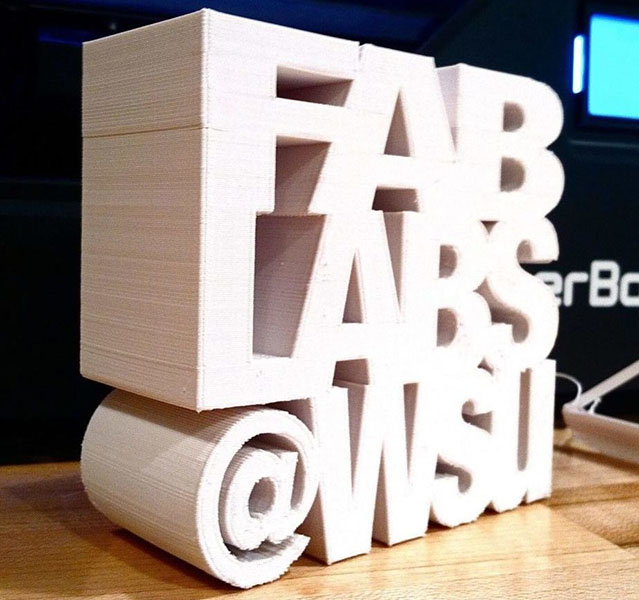 Wood sculpture forming the words Fab Labs @ WSU.