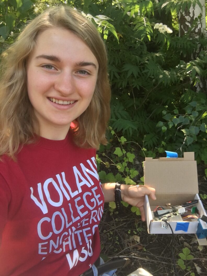 Elli Ehinger holding her air quality sensor.