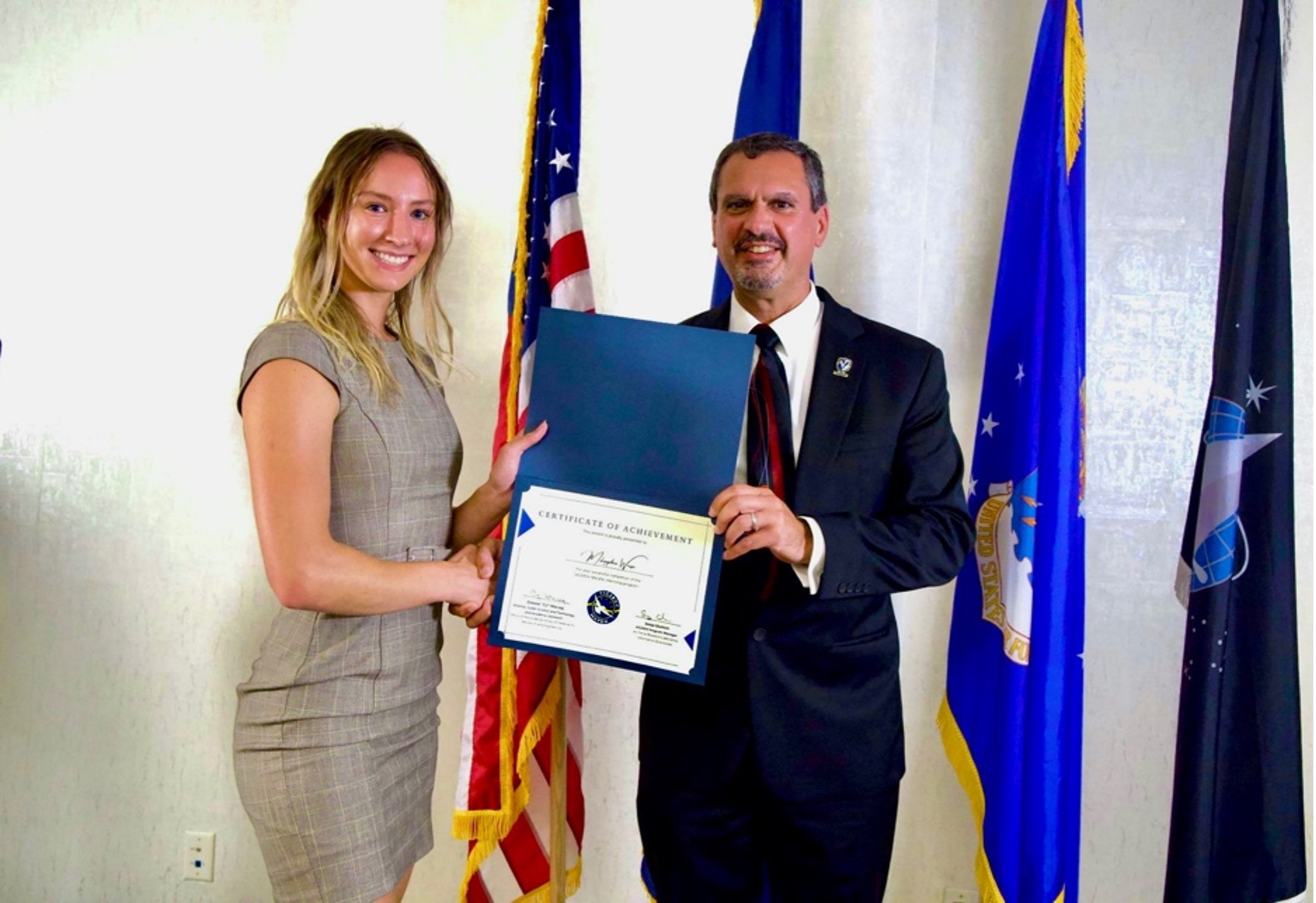 Woman being presented with an award.