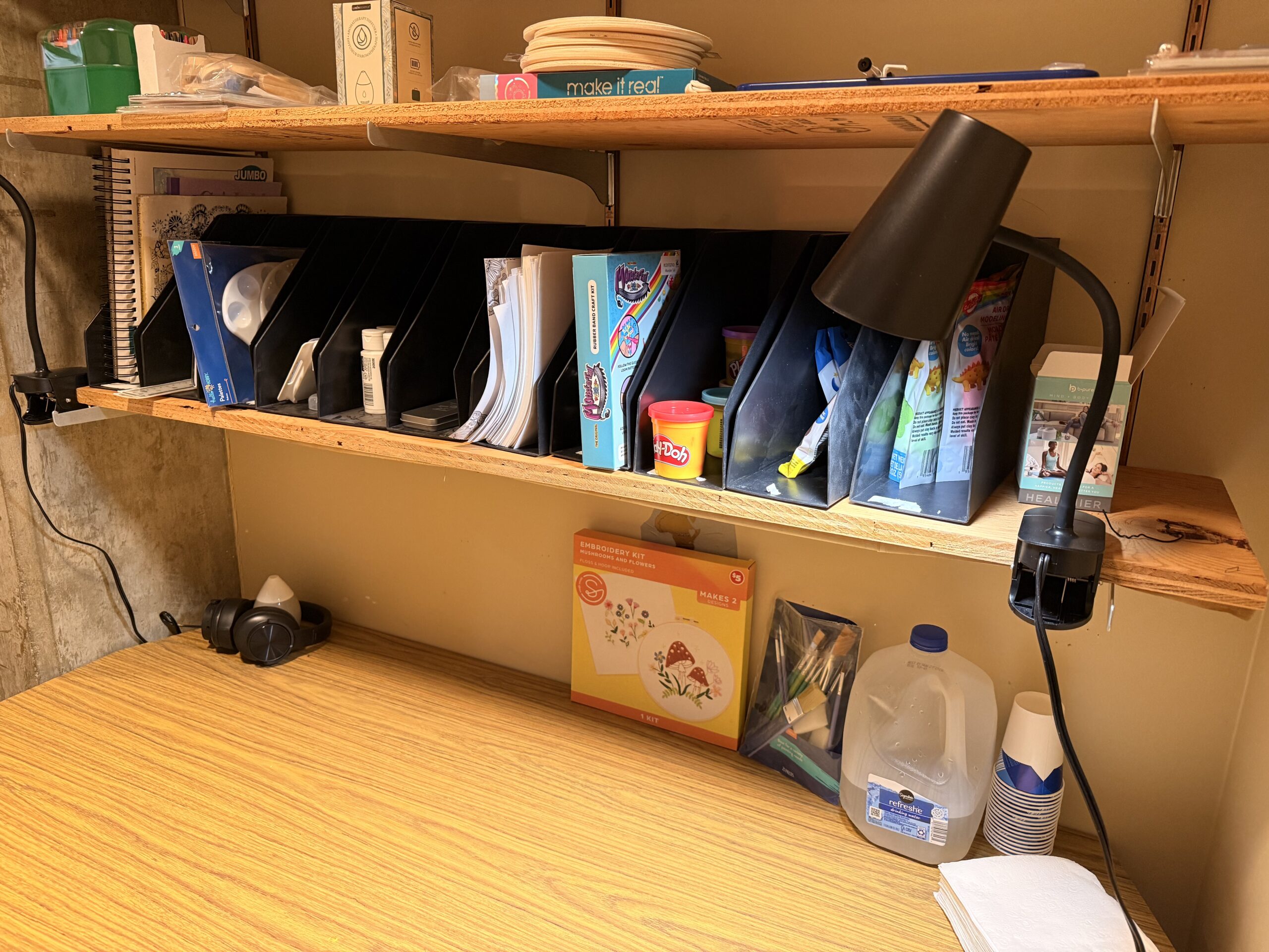 Desk with a variety of paint supplies.