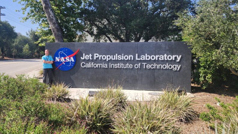 Man standing next to NASA JPL sign.
