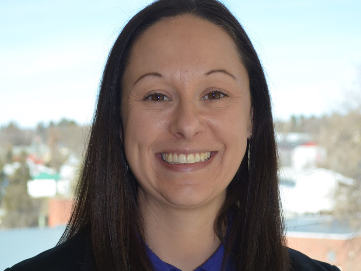 Alena Hume's professional headshot. A woman smiling in the camera.