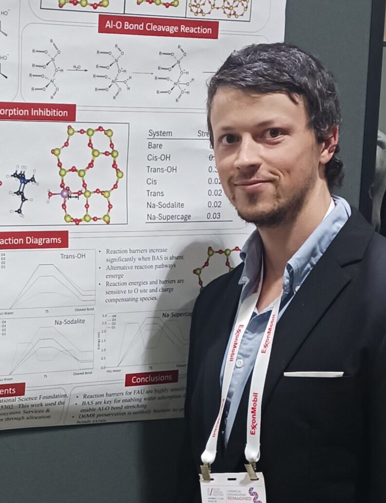 Person wearing a lanyard poses in front of a poster that shows chemical bond structures.