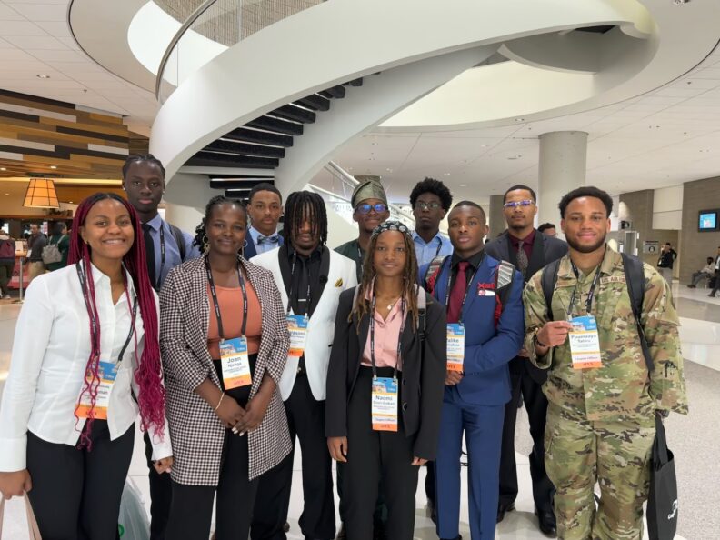 A group of persons wearing lanyards, posing for a picture.