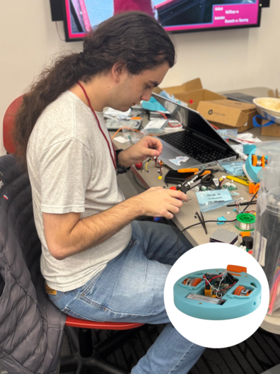 A person holding pliers, examining the components of a circuit board laid out on a workbench in front of him.
