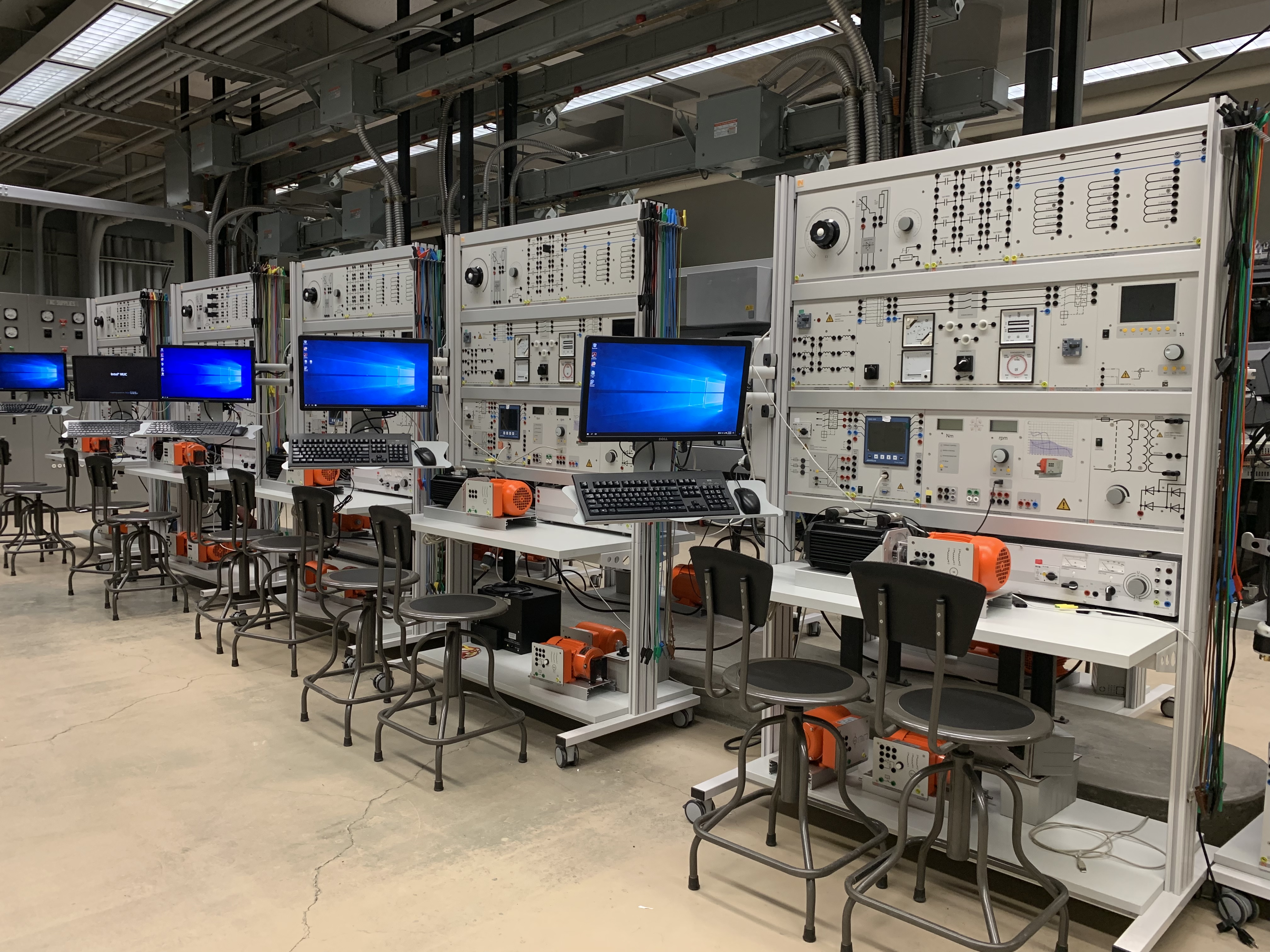 The pictured room contains several computers, chairs, and energy conversion equipment.