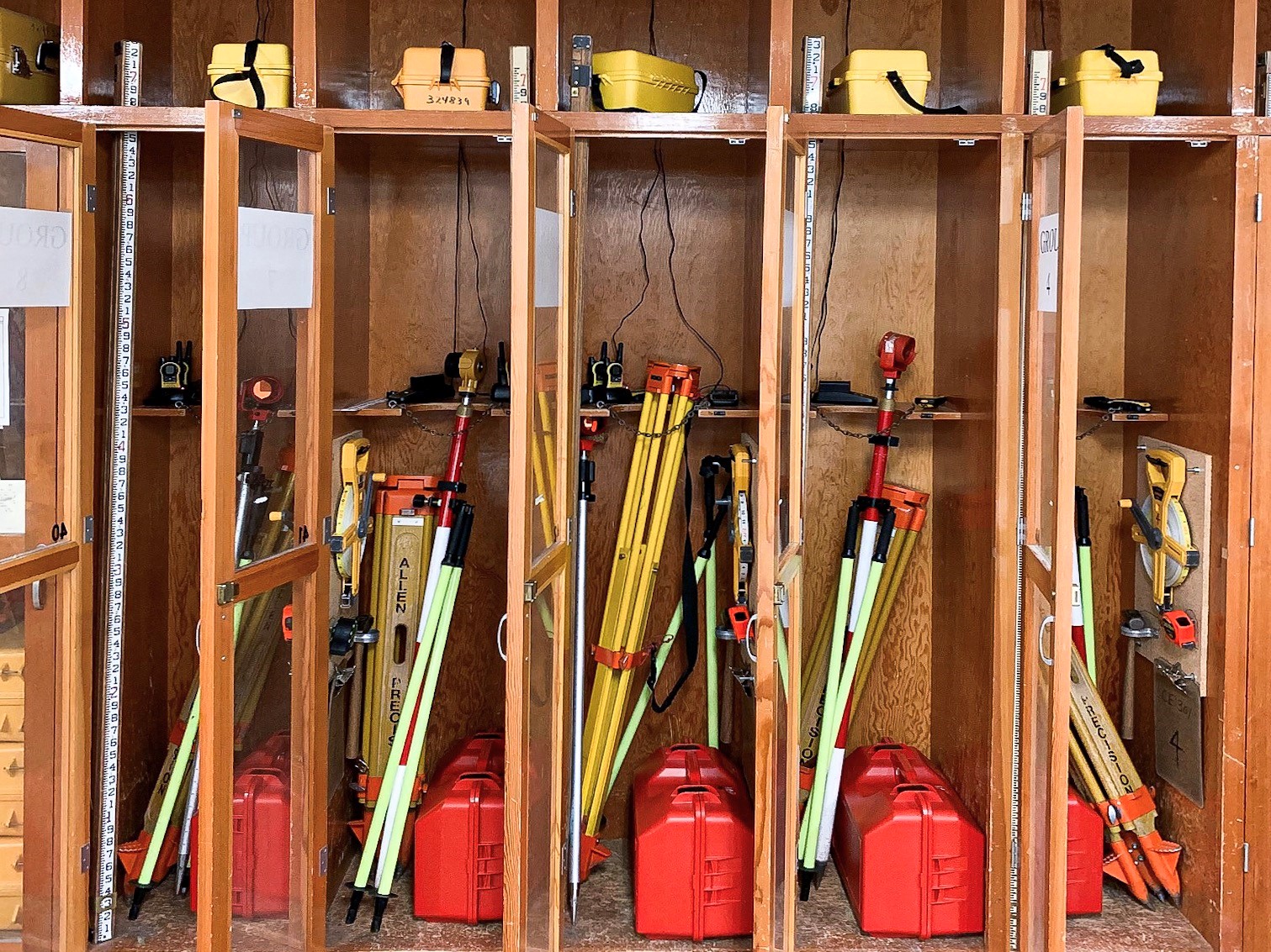 This photos shows several survey equipment and the individual storage containers of the equipment.