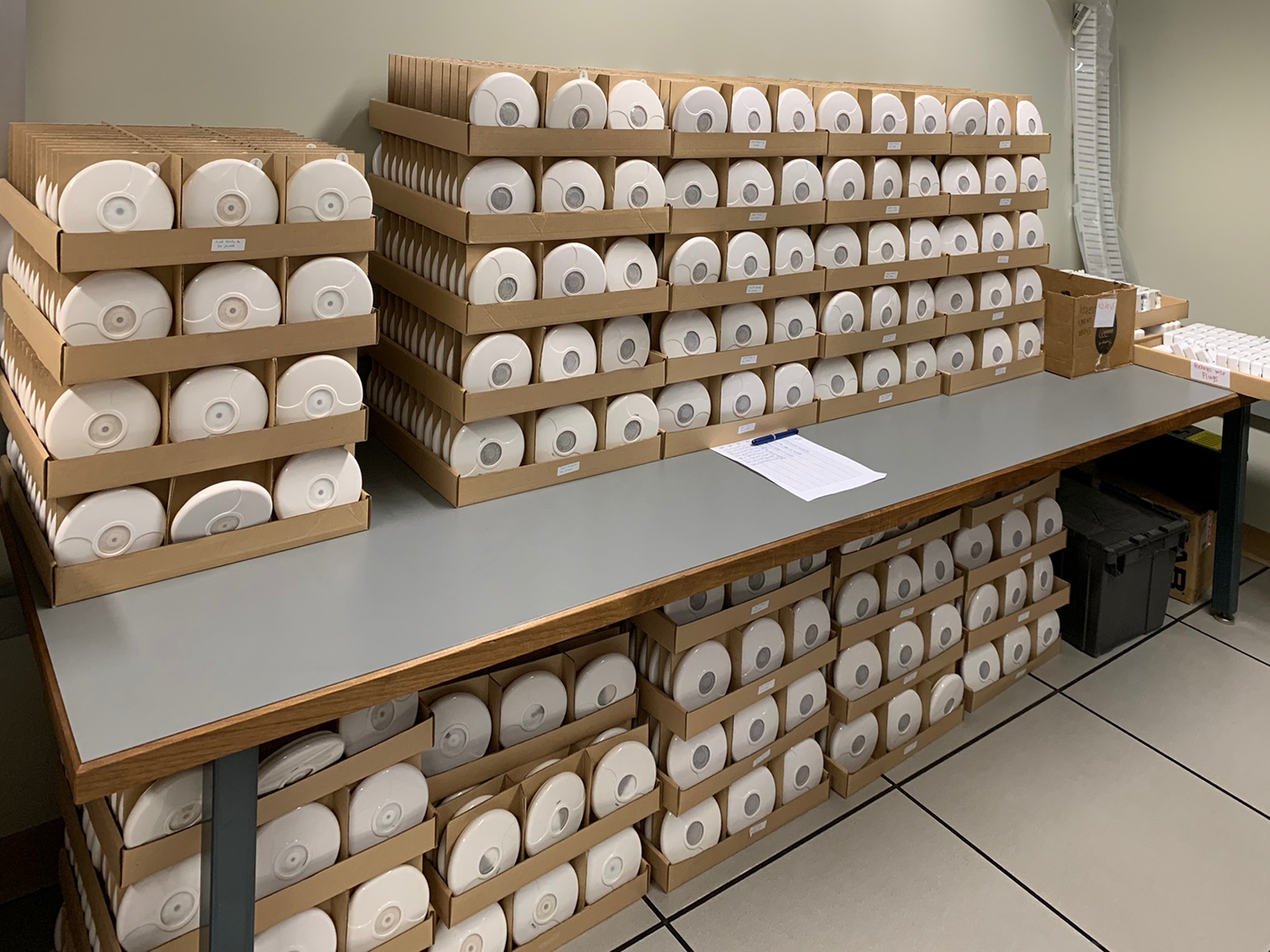 Several boxes of motion sensors used by the Smart Homes Lab.