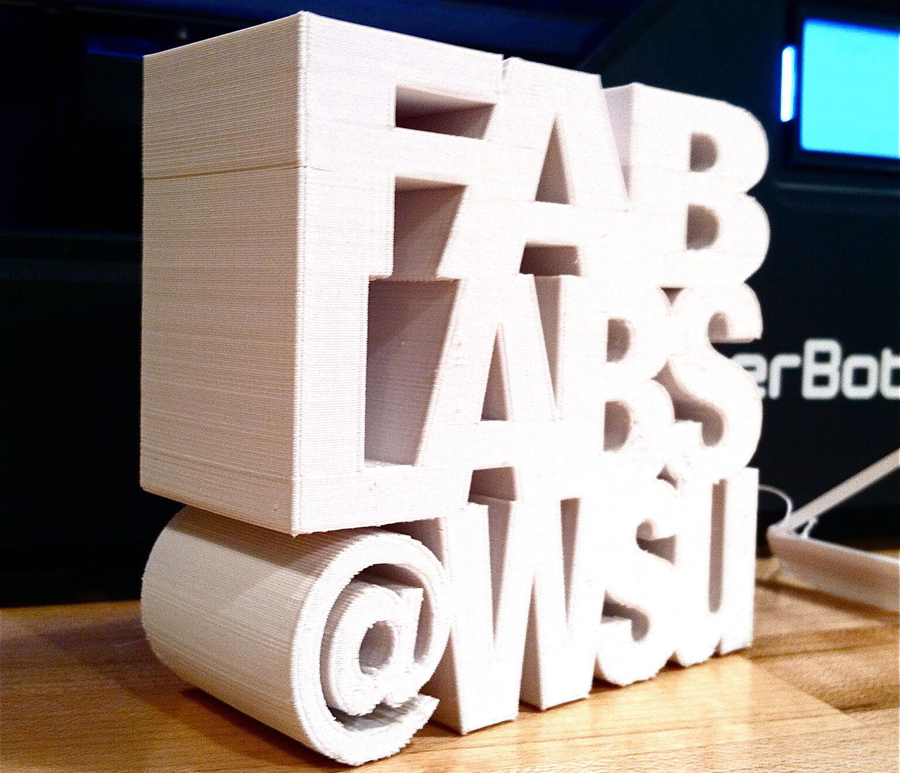 Wood carving that reads Fab Labs @WSU.