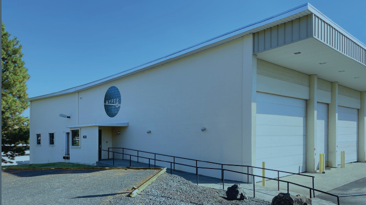 white building with the HYPER lab logo and multiple garage bays.