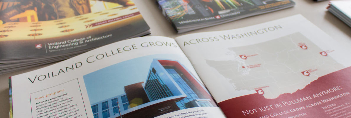 Printed Voiland College magazines displayed on a table.