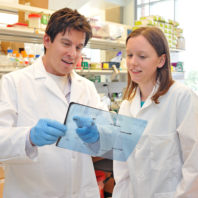 Dr. Goodman and Keesha in the lab looking at a slide