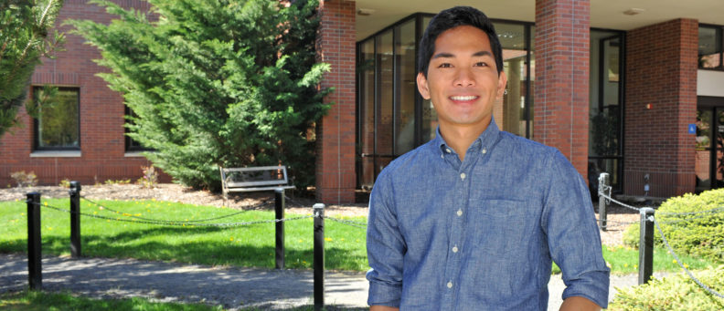 Josh standing in front of the WSU veterinary teaching hospital