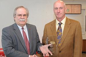 Dr. Budsbert receiving award from Dean Slinker.