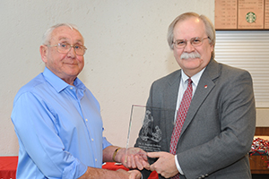 Dr. Elefson receiving award from Dean Slinker.