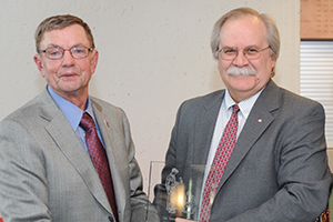 Dr. Brown receiving award from Dean Slinker.