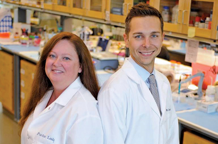 Dr. Rita Fuchs and Dr. Ryan McLaughlin in a lab.