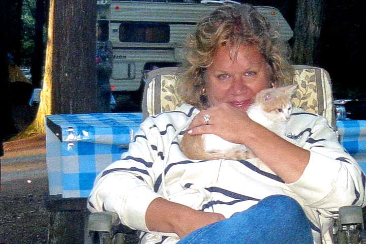 Susan at a campground, holding a kitten.