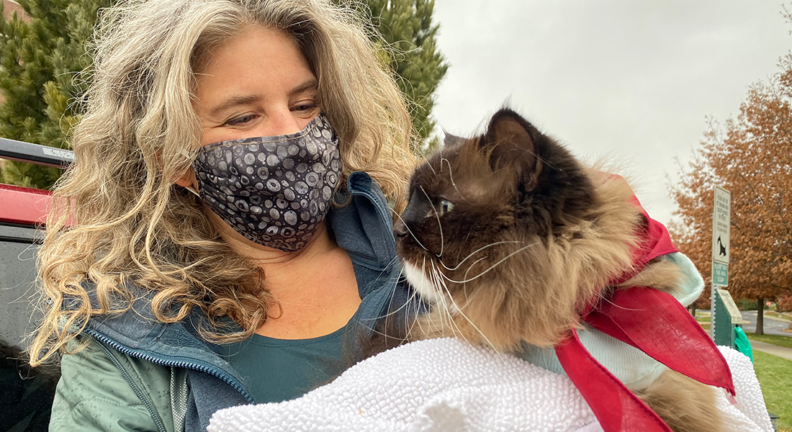 Mocha being held by his owner, outside the vet hospital.