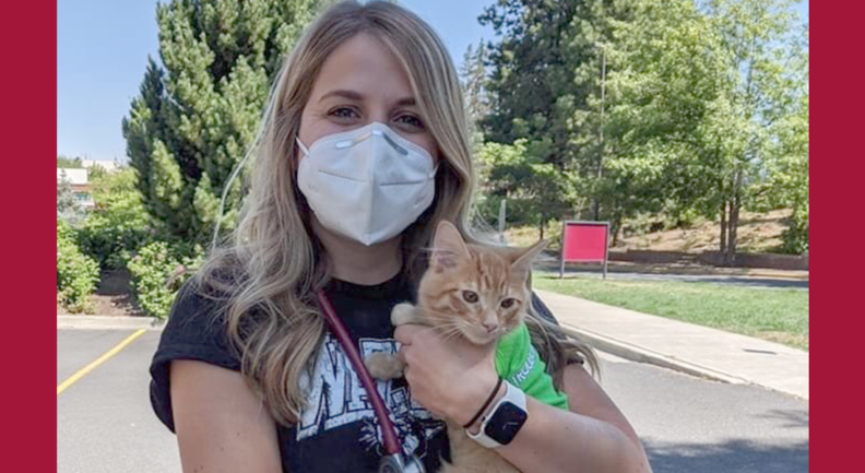 Carly Ellingsen holding a cat outside the vet hospital.
