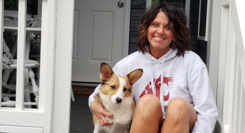 Kristy Fiorini sitting on her front porth with her corgi, Murray.