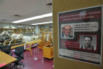 Sign at entry introducing Drs. Worthman and Johnson. Part of the museum displays are viewable in the background.