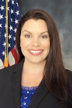 Dr. Pieracci in the studio with an American flag in the background.